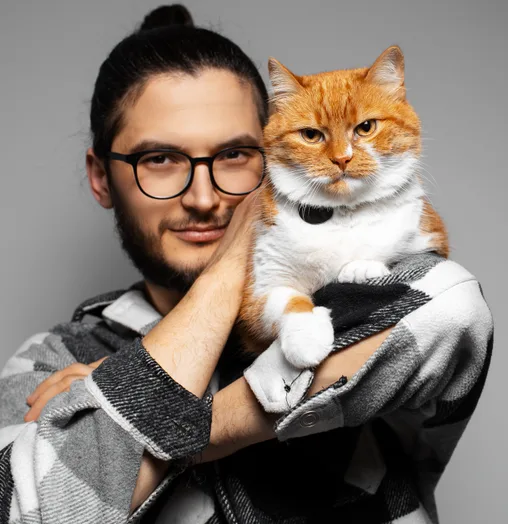 Pet owner smiling and holding cat