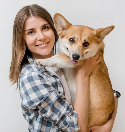Happy owner holding pet dog