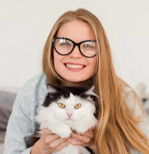 Smiling pet owner holding cat