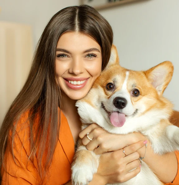 Happy owner hugging pet dog