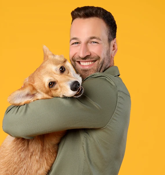 Happy owner holding pet dog