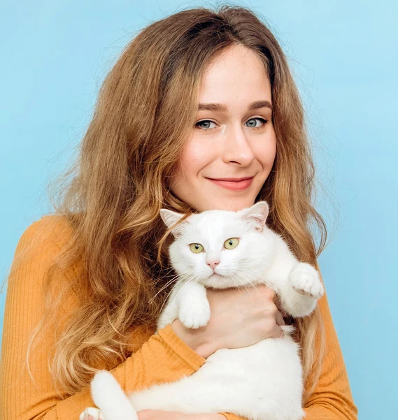 Happy pet owner holding cat