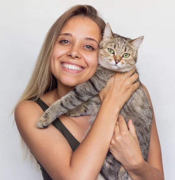 Smiling pet owner holding cat