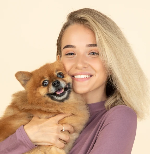 Happy pet owner smiling with puppy