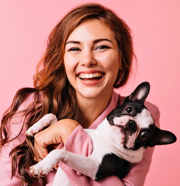 Smiling owner holding pet dog