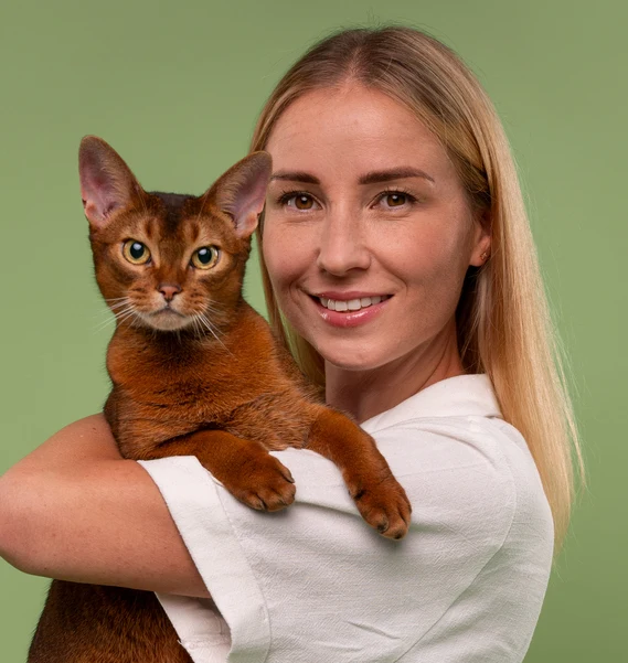 Smiling owner holding pet cat